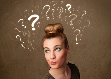 Teenage girl with question mark symbols around her head Teenage girl with question mark symbols around her head